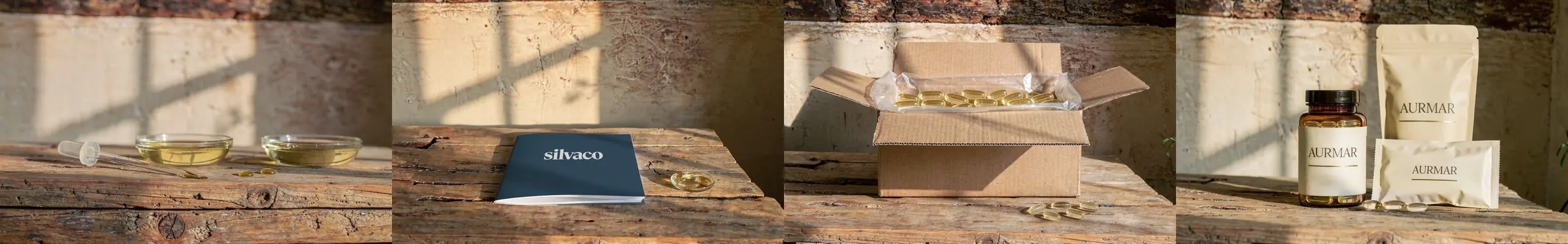 Three dishes of golden marine oil and a pipette on a rustic oak table